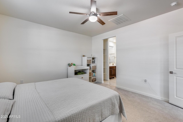 bedroom featuring connected bathroom, ceiling fan, and light colored carpet