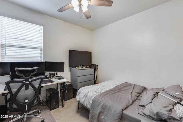 bedroom featuring ceiling fan and light carpet