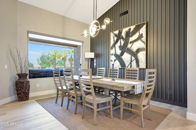 19745 N Mountain Sage Ln, Surprise, AZ 85374 - dining space featuring an accent wall and wood finished floors