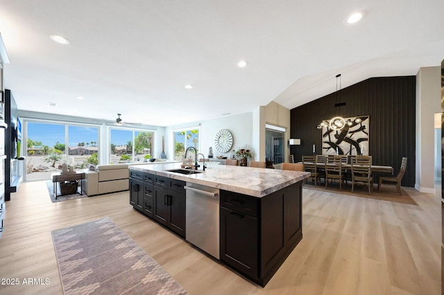 19745 N Mountain Sage Ln, Surprise, AZ 85374 - kitchen with stainless steel dishwasher, open floor plan, a kitchen island with sink, light countertops, and dark cabinetry