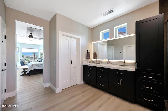 19745 N Mountain Sage Ln, Surprise, AZ 85374 - ensuite bathroom with wood finished floors, double vanity, and ceiling fan
