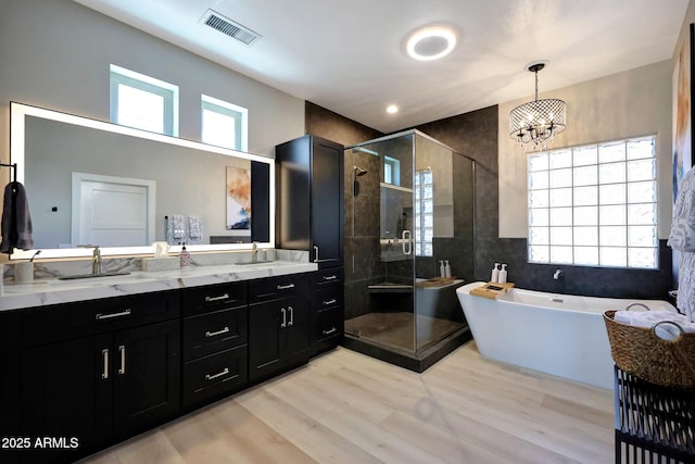 19745 N Mountain Sage Ln, Surprise, AZ 85374 - bathroom with a stall shower, double vanity, a freestanding bath, and a chandelier