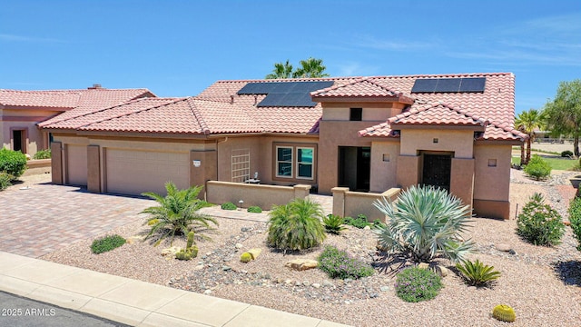 19745 N Mountain Sage Ln, Surprise, AZ 85374 - view of front of house featuring stucco siding, an attached garage, a tile roof, driveway, and roof mounted solar panels