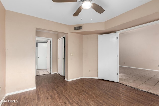 spare room with ceiling fan and dark wood-type flooring