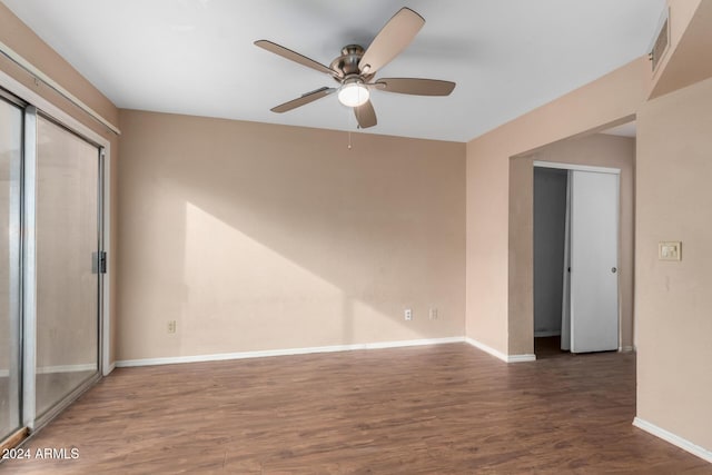 unfurnished bedroom with ceiling fan and dark wood-type flooring