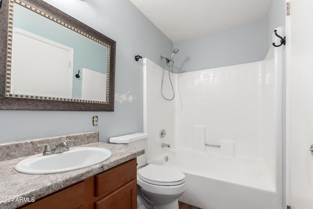 full bathroom with toilet, vanity, and washtub / shower combination