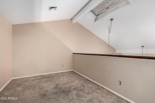 interior space with carpet floors and lofted ceiling with skylight