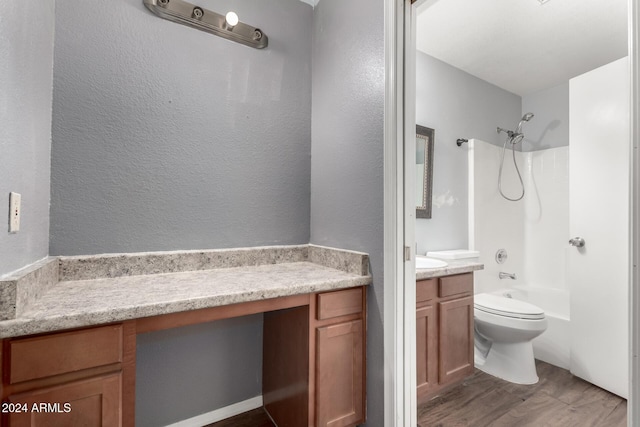 full bathroom with shower / bath combination, vanity, wood-type flooring, and toilet