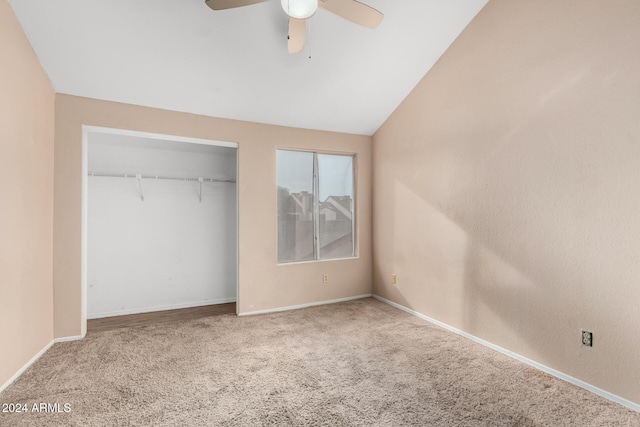 unfurnished bedroom featuring ceiling fan, a closet, carpet floors, and vaulted ceiling