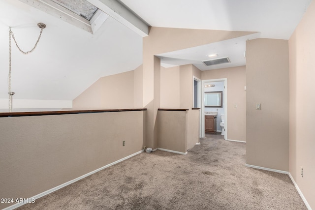 corridor featuring vaulted ceiling with beams and light colored carpet