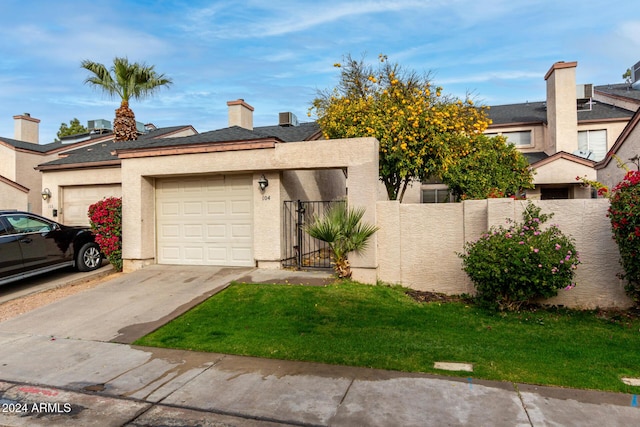 view of front of house featuring a garage and a front lawn