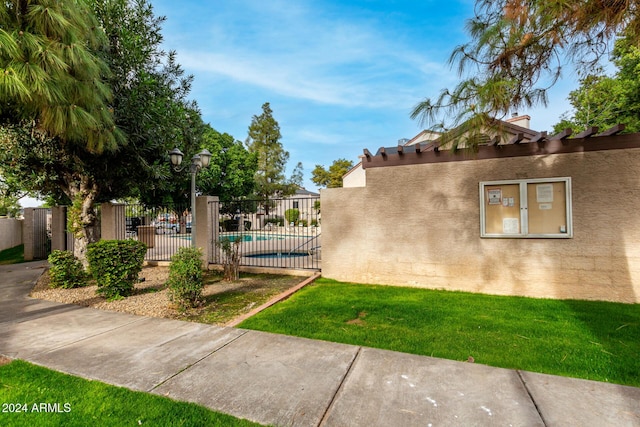 exterior space with a fenced in pool