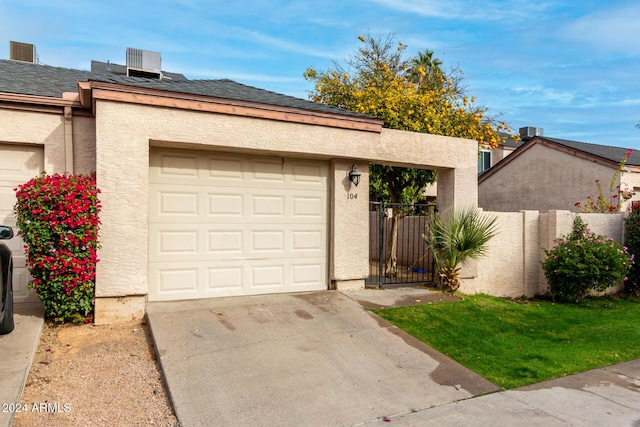 view of front of house with central AC unit and a garage