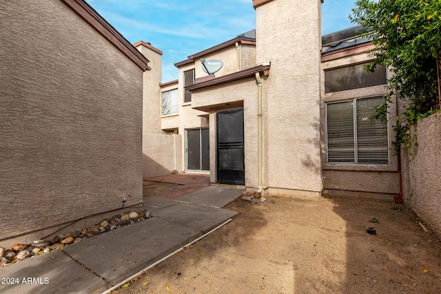 entrance to property featuring a patio area