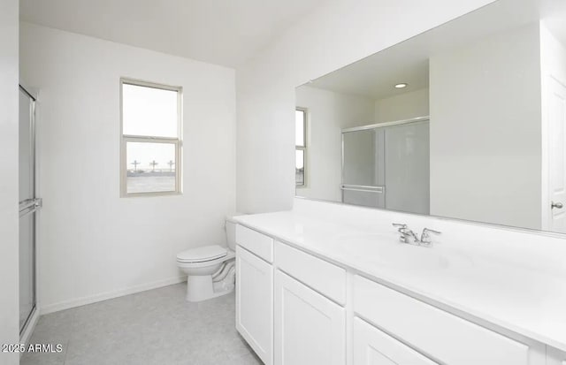 bathroom featuring baseboards, a shower stall, toilet, and vanity