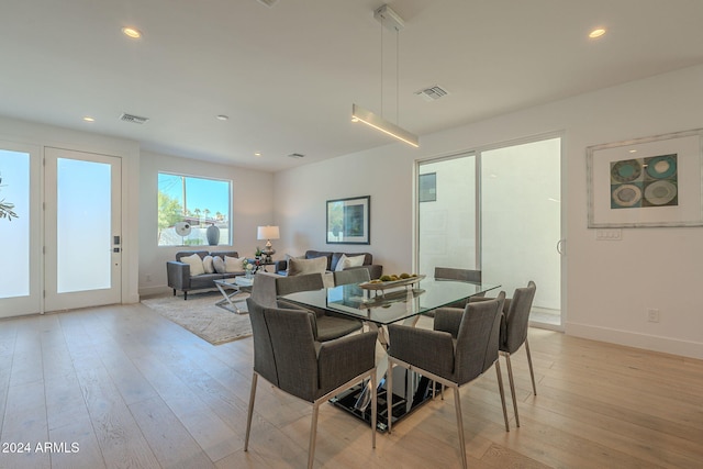 dining space with light wood-type flooring