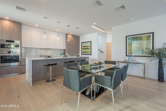 dining area with light hardwood / wood-style floors