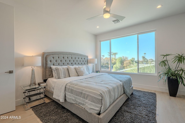 bedroom with light hardwood / wood-style floors and ceiling fan