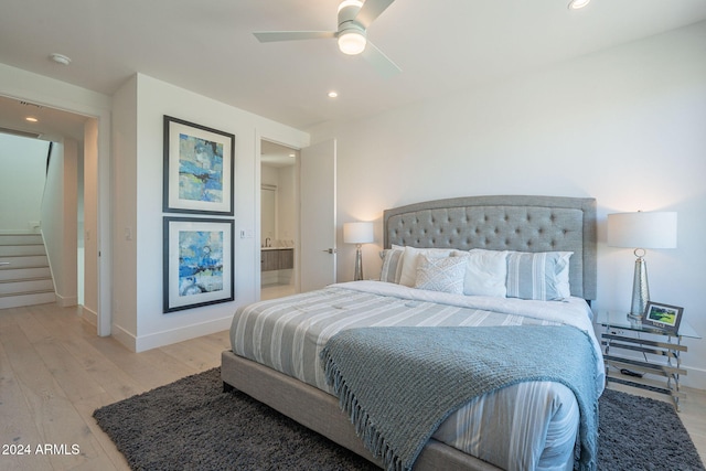 bedroom with light hardwood / wood-style floors, ceiling fan, and ensuite bathroom