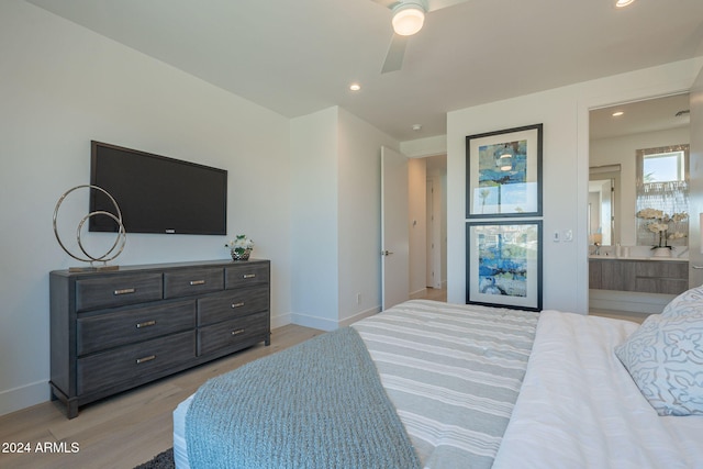 bedroom with ceiling fan, ensuite bathroom, and light hardwood / wood-style floors