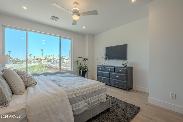 bedroom with ceiling fan and light hardwood / wood-style flooring