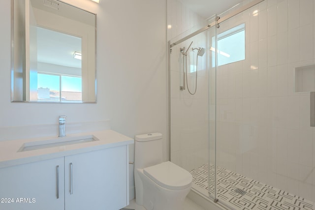 bathroom with a shower with door, vanity, and toilet