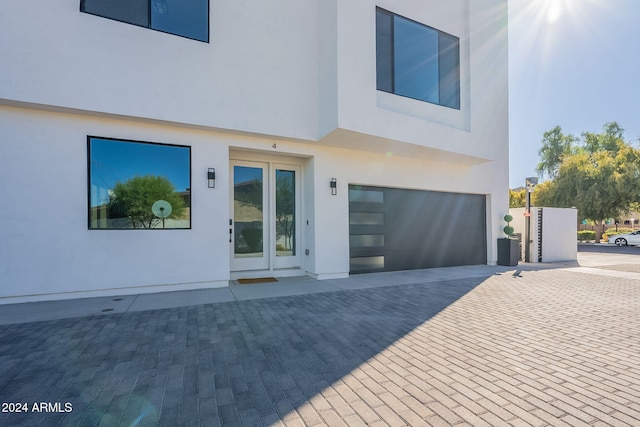 rear view of property featuring a garage