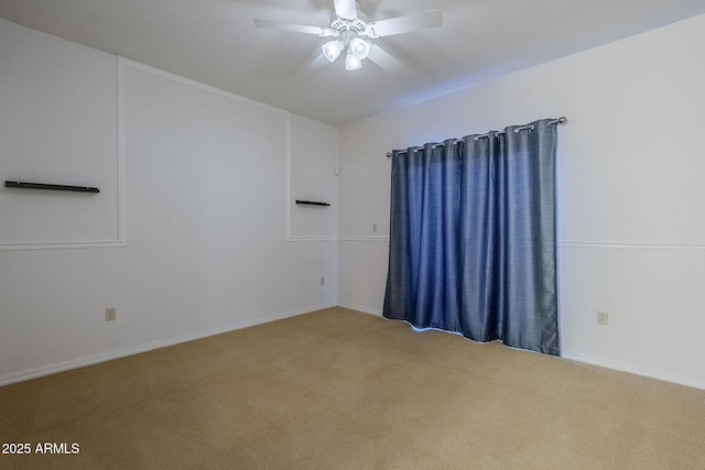 carpeted empty room featuring ceiling fan