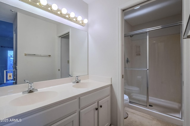 bathroom featuring vanity, toilet, and walk in shower