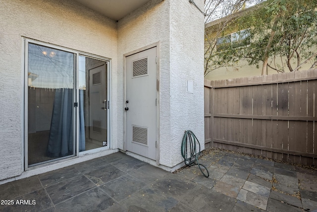 entrance to property with a patio