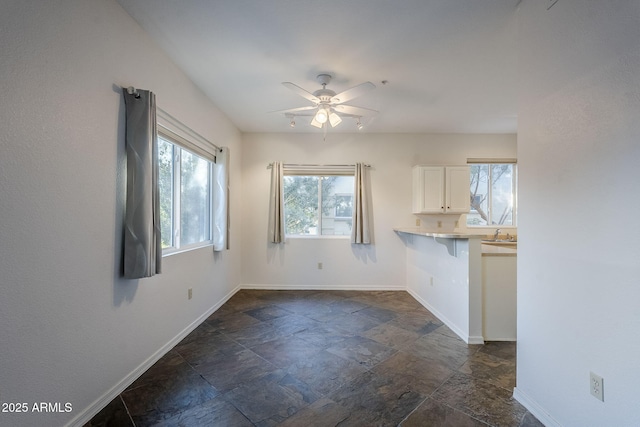 interior space featuring ceiling fan and sink