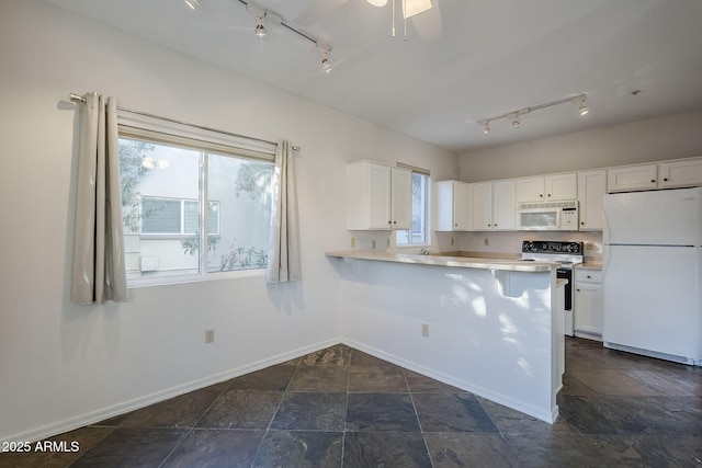 kitchen with kitchen peninsula, white appliances, ceiling fan, white cabinets, and a breakfast bar area