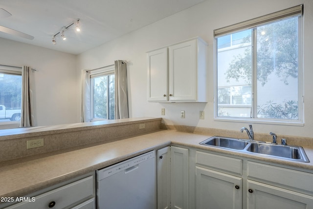 kitchen featuring white dishwasher, white cabinetry, sink, and track lighting