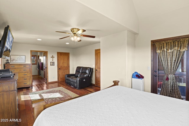 bedroom featuring dark hardwood / wood-style floors, ceiling fan, and ensuite bathroom