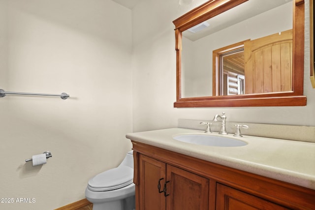 bathroom featuring vanity and toilet