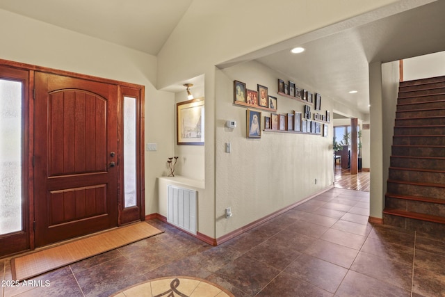 tiled entryway featuring lofted ceiling and a healthy amount of sunlight