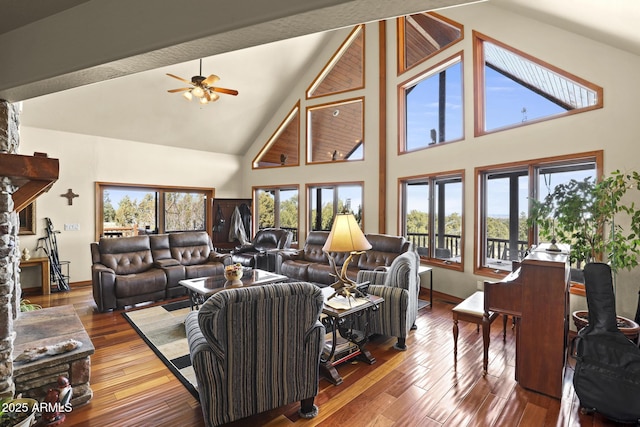 living room featuring wood-type flooring, high vaulted ceiling, and plenty of natural light