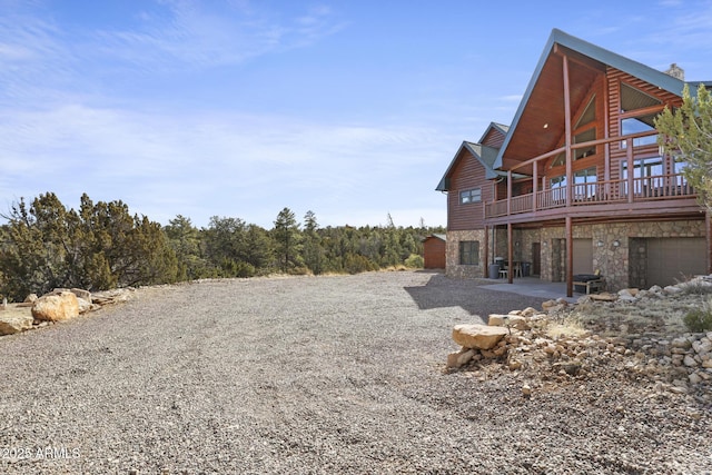 view of yard with a garage and a deck