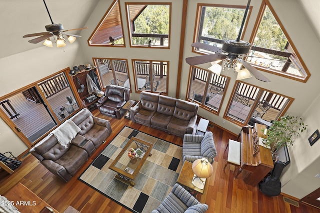 living room featuring a towering ceiling and wood-type flooring