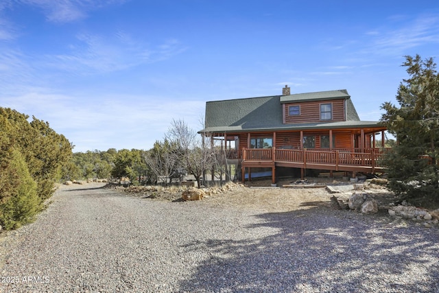 rear view of house with a wooden deck