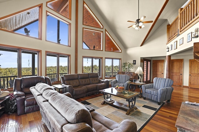 living room with dark hardwood / wood-style flooring, high vaulted ceiling, and ceiling fan