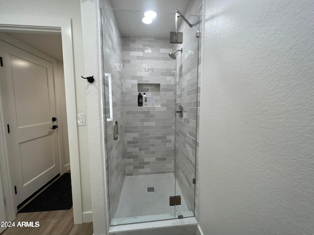 bathroom featuring a shower with shower door