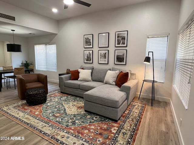 living room with ceiling fan and hardwood / wood-style floors