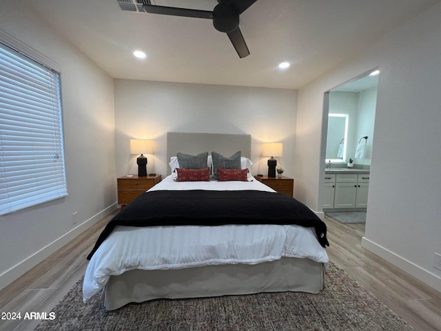 bedroom featuring ceiling fan, light wood-type flooring, and connected bathroom