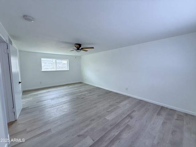 unfurnished bedroom featuring ceiling fan, baseboards, and light wood-style floors