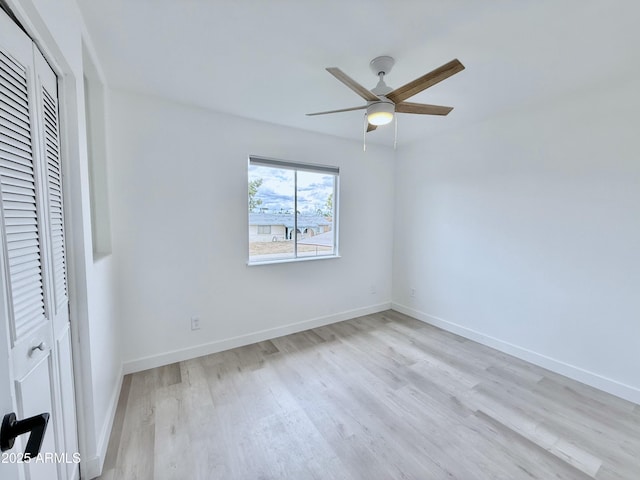 unfurnished bedroom with a closet, baseboards, and wood finished floors