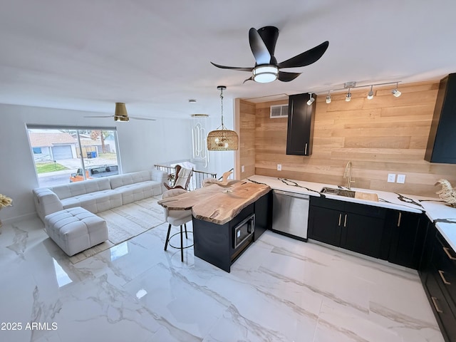 kitchen featuring visible vents, marble finish floor, open floor plan, dishwasher, and dark cabinets