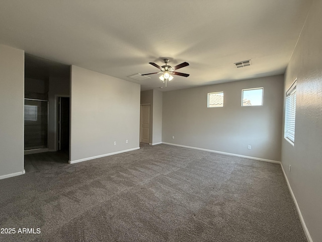 unfurnished room featuring dark colored carpet and ceiling fan