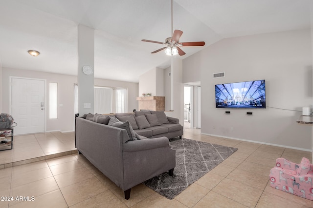 tiled living room with ceiling fan and lofted ceiling