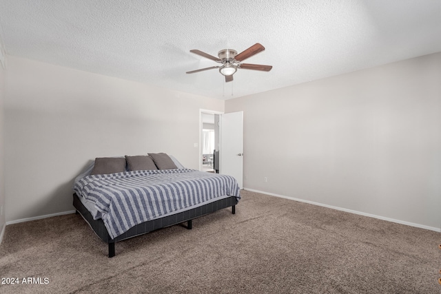 carpeted bedroom featuring a textured ceiling and ceiling fan